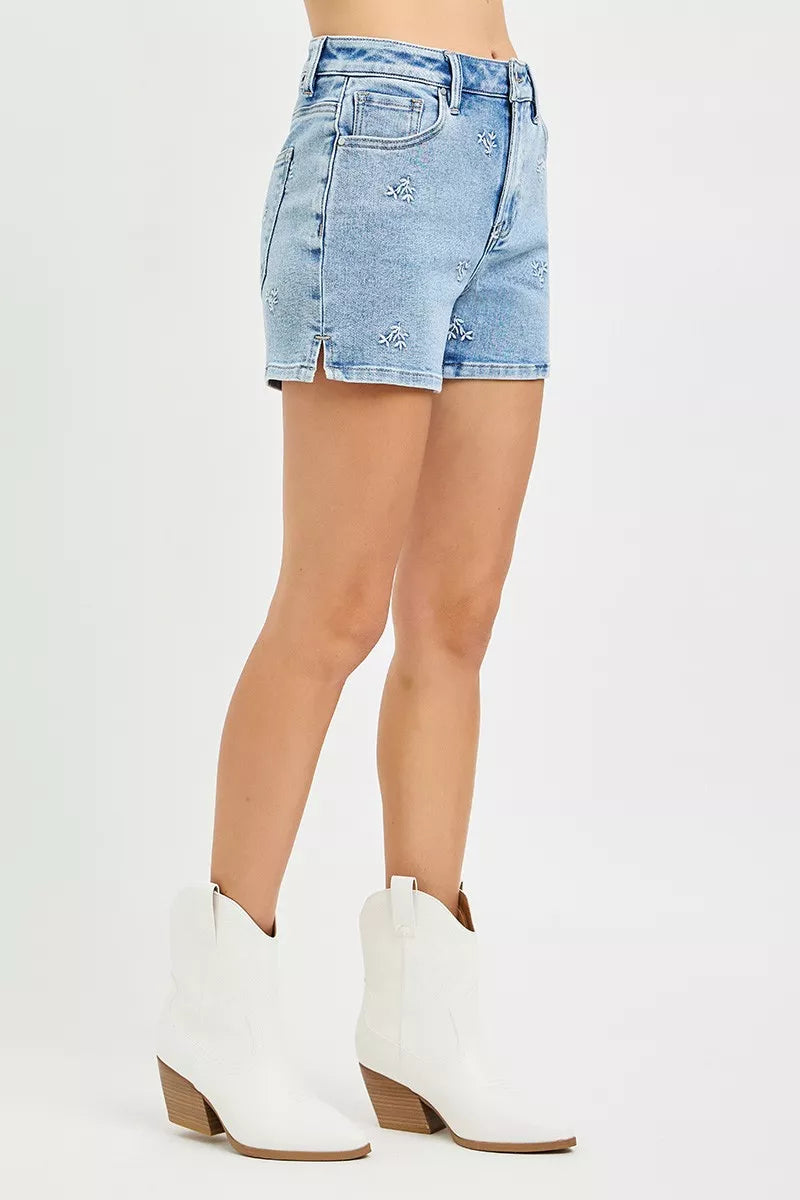 Denim shorts worn by a person on a white background