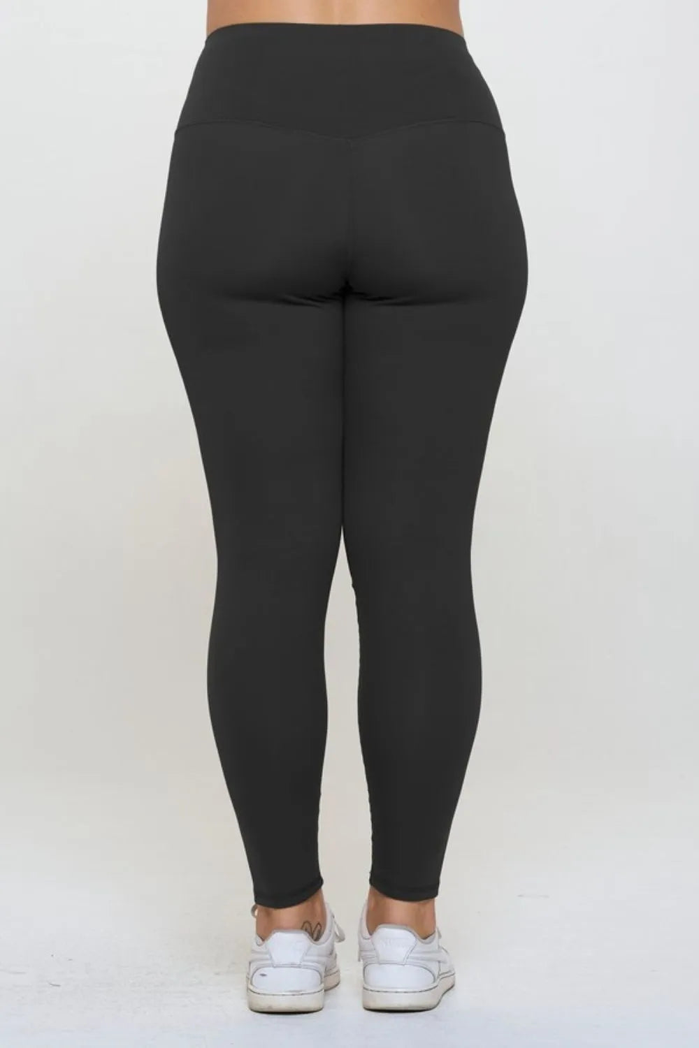 Black leggings worn by a person on a white background