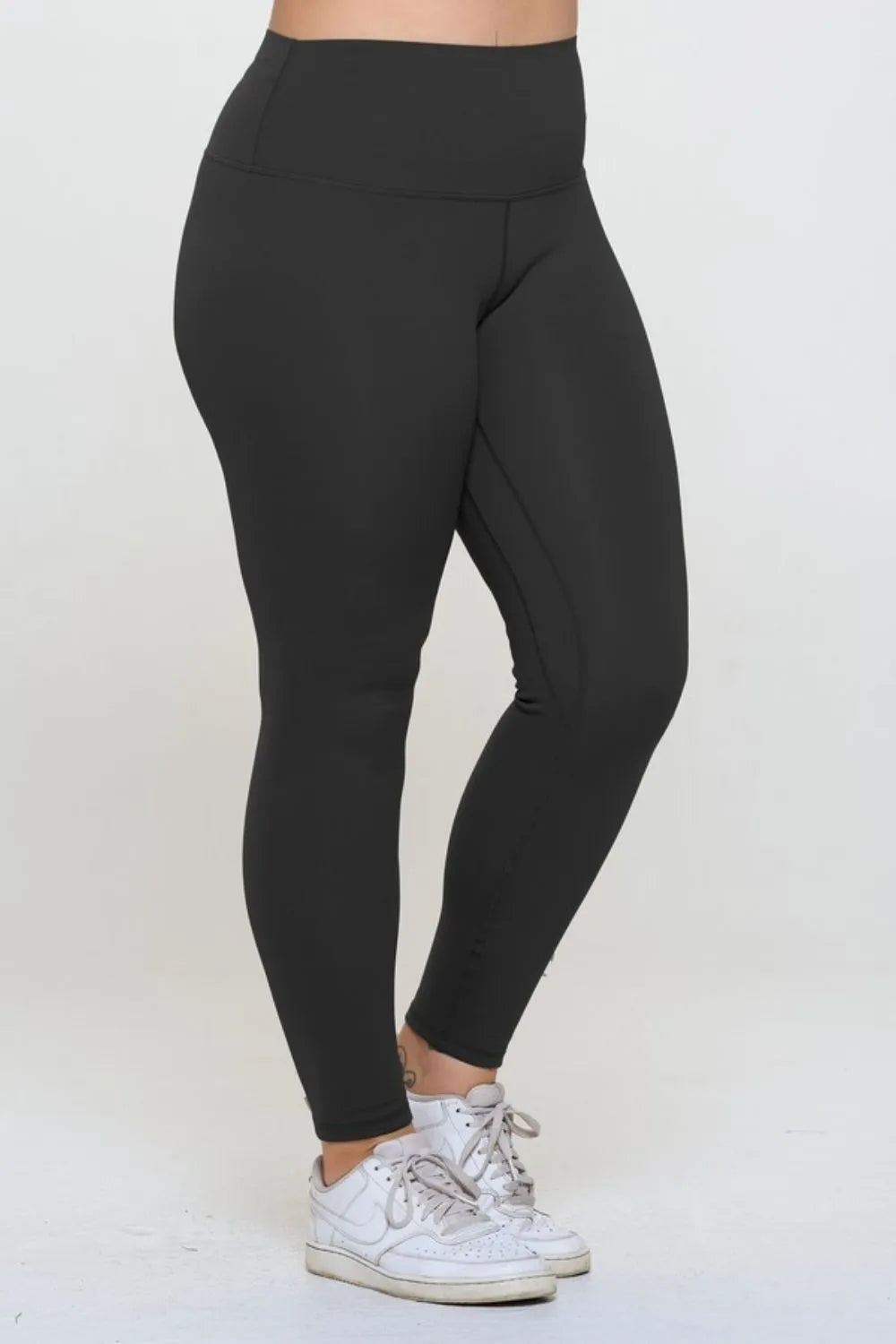 Black leggings worn by a person on a white background