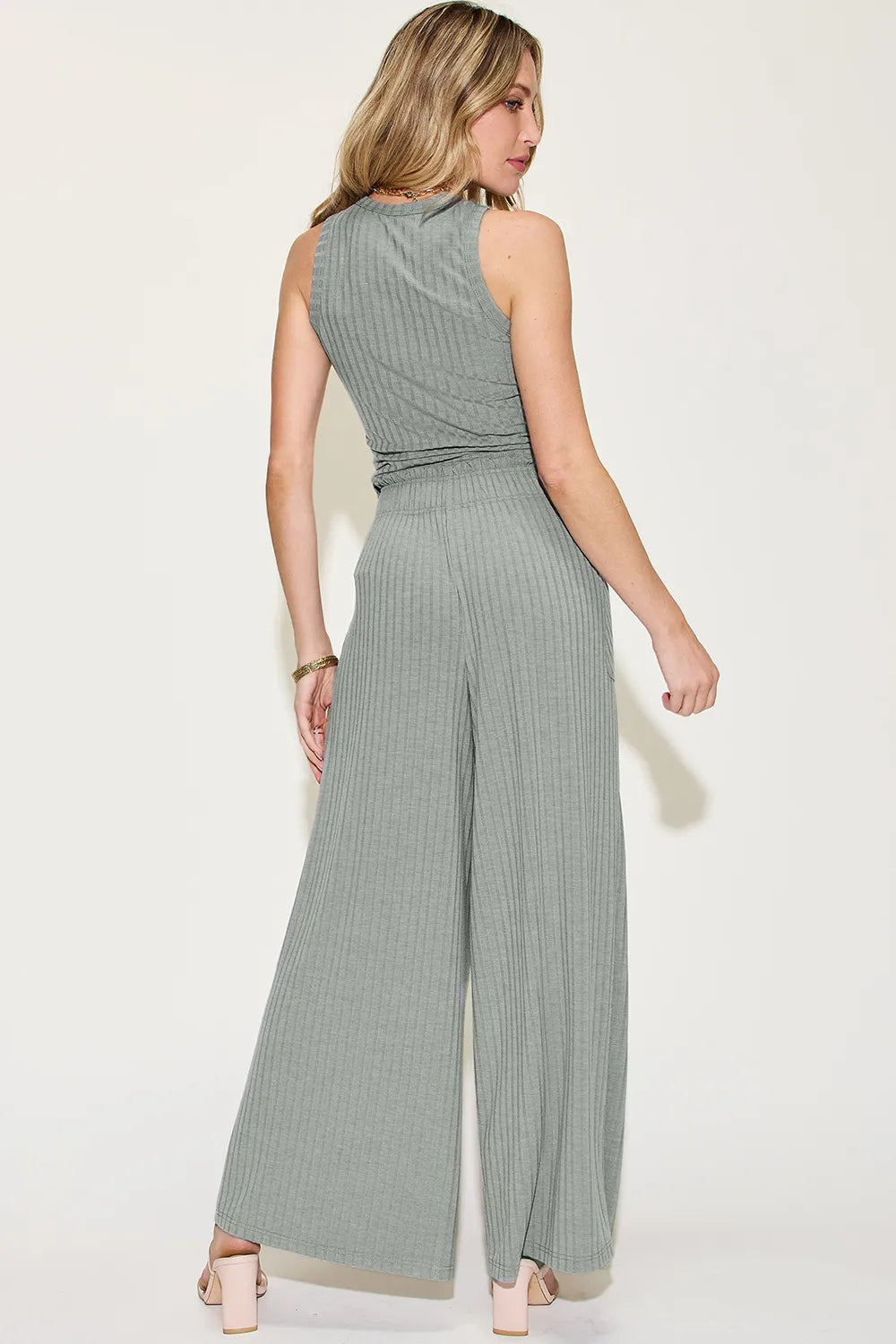Woman wearing a green jumpsuit on a white background